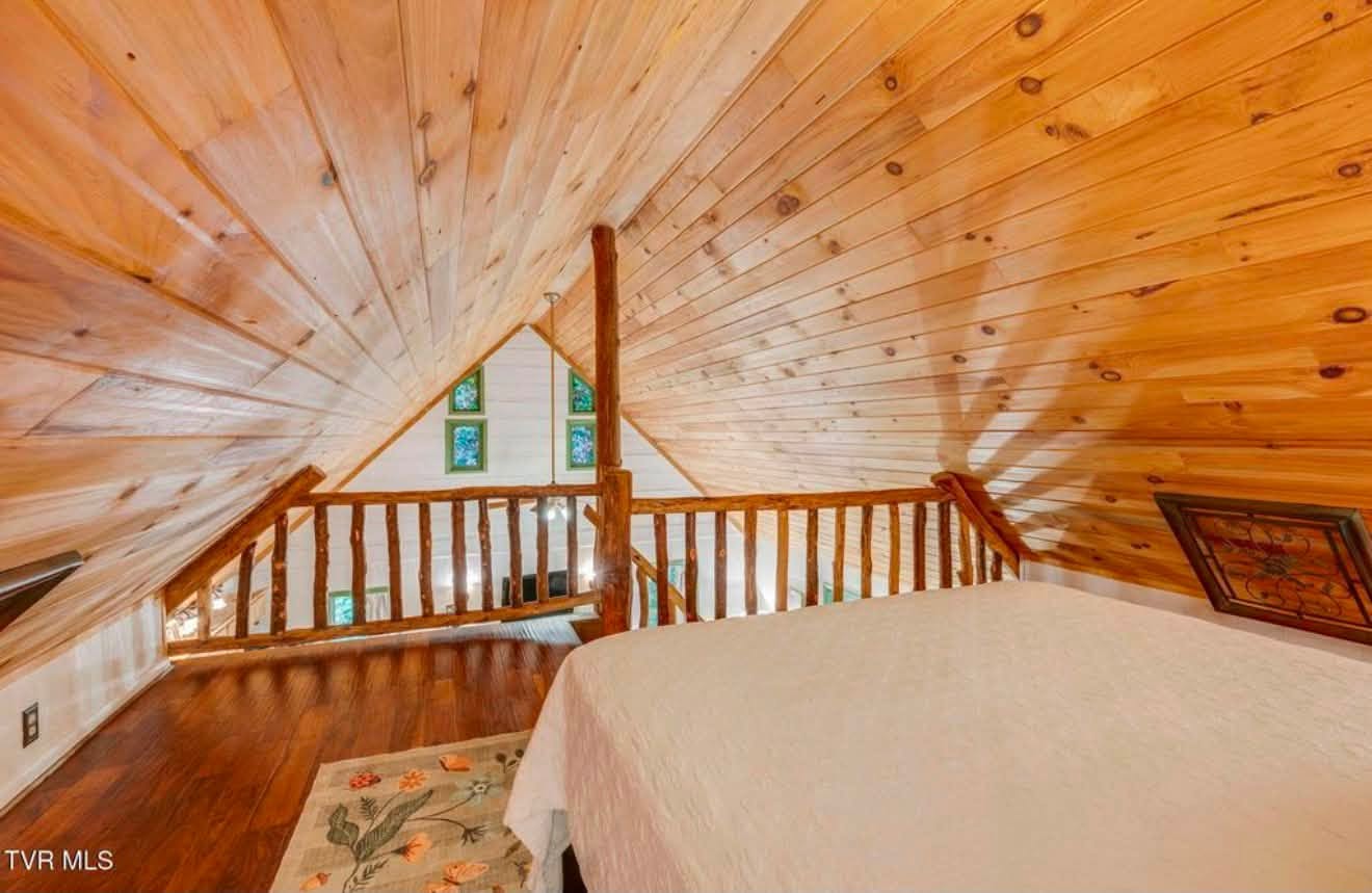 Bear cabin view from loft along rustic wood railing